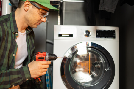 Technician providing washer repair in Glendale CA fixing a front load washing machine for a homeowner with same day service