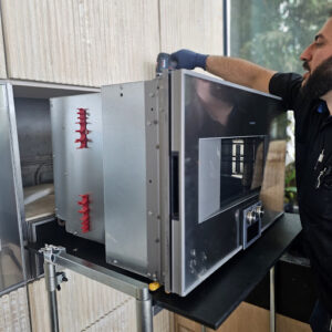 Technician repairing Gaggenau steam oven control panel and internal components in Los Angeles