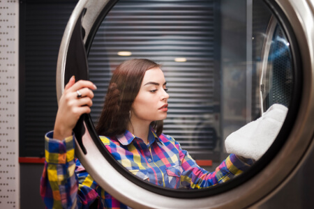 CityFix technician testing heating element and drum belt on a dryer in Los Angeles