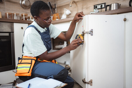 CityFix Appliance technician repairing a built-in refrigerator compressor in Los Angeles