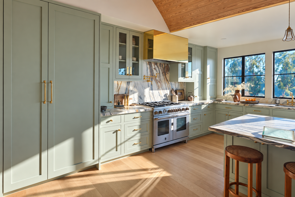 Custom cabinetry, a panel-ready refrigerator, stainless steel range, and hardwood floors